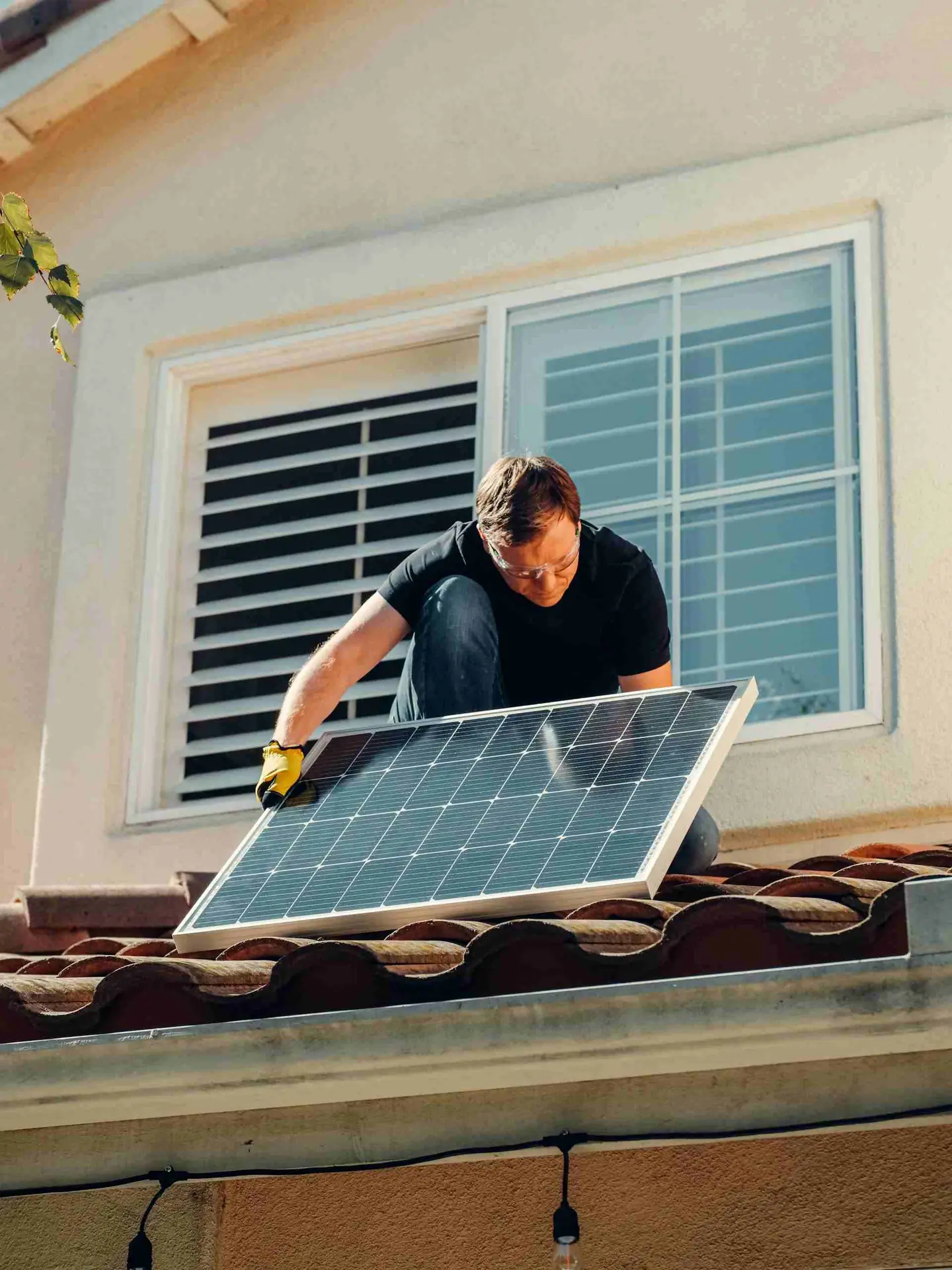 Workers installing solar panels on residential rooftop – home PV system under construction