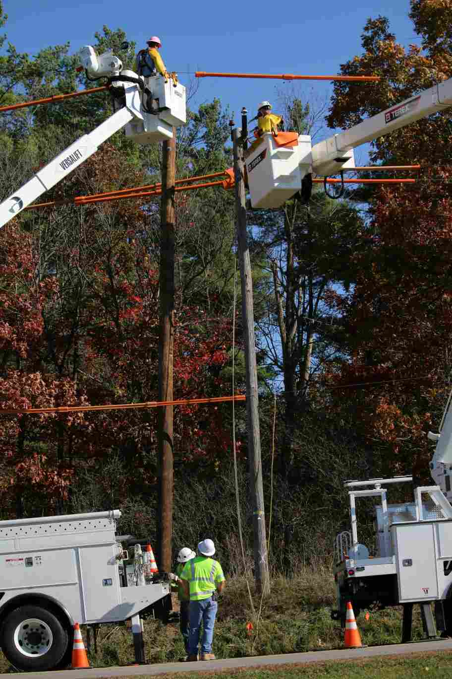 Industrial park during power shortage – electricians repairing circuit panel at factory site